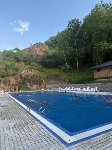 a group of people in a swimming pool at Ugam Mountain apartments in Khumson