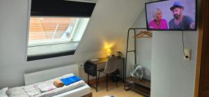 a room with a bed and a tv on a wall at Sonnige Ferienzimmer WHV in Wilhelmshaven +50 photos