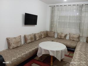 a living room with a couch and a table at Asrati in Ifrane