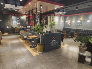 a restaurant with chairs and a bar with plants at 범어사 범어호텔 in Ch'ŏngnyong-dong