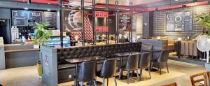 a restaurant with black chairs and a bar at 범어사 범어호텔 in Ch'ŏngnyong-dong +13 photos