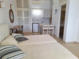 a living room with two beds and a kitchen at Panthea Residence in Agios Ioannis Mykonos