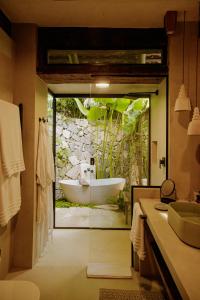 a bathroom with a bath tub and a sink at Casa Salga in Ilhabela +70 photos