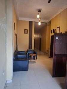 a living room with two blue couches and a table at Penginapan 369 in Sentani