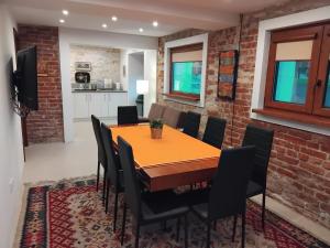 a dining room with a table and chairs at Hedgehog Villa - Вила Таралеж in Velingrad