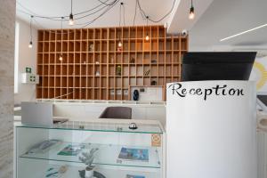 a display case in a store with a reputation sign at Avis Hotel in Novalja +175 photos