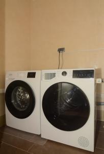 a washing machine and a dryer in a room at Brunnenhof - Serviced Apartments in Bekond