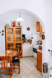a kitchen with a wooden table and a dining room at Ormos Isternia House in Istérnia