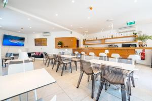 a dining room with tables and chairs in a restaurant at Avis Hotel in Novalja
