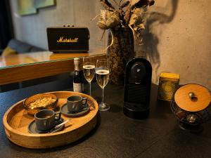 a table with two glasses of wine and a bottle of champagne at Tatry Premium Apartment - PRIVATE Parking in Kežmarok