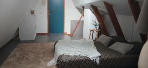 a bedroom with a bed with a white blanket on it at Mon petit chalet in Puycornet