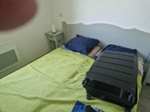 a suitcase sitting on a bed in a bedroom at demeure du ventoux in Aubignan