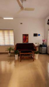 a living room with a couch and a table at Purayilhomestay in Varkala