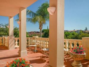 a patio with a table and chairs on a deck at LaTorrettaLoano Affittacamere in Loano