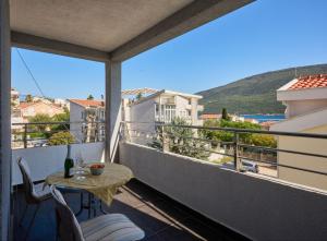 a balcony with a table and chairs and a view at LUNA lux in Đenovići