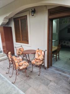 a table and chairs sitting on a patio at Apartman Angela in Igalo