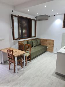 a living room with a couch and a table and chairs at Apartman Angela in Igalo