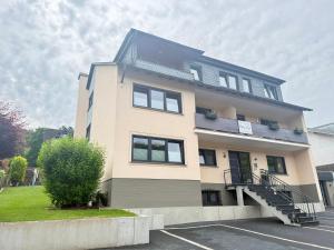 a tall building with a staircase in a parking lot at Ferienwohnungen Haus Jose in Cochem