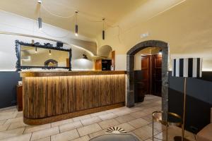 a bar in a restaurant with a mirror at Capomulini Boutique Hotel in Capo Mulini