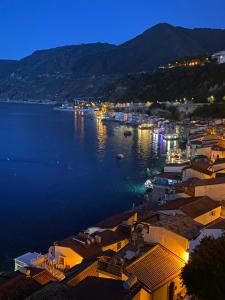 a view of a town on the water at night at Chianalea Guesthouse in Scilla +57 photos