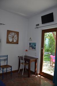 a dining room with a table and chairs and a sliding glass door at Sunray Room for Two in Zagora in Zagora