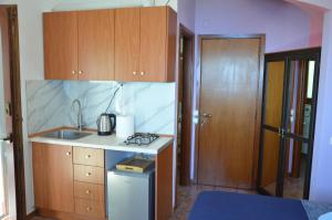 a small kitchen with a sink and a stove at Sunray Room for Two in Zagora in Zagora
