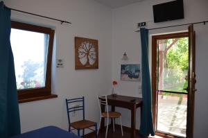 a room with a table and chairs and a window at Sunray Room for Two in Zagora in Zagora +18 photos