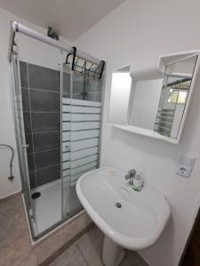 a white bathroom with a sink and a shower at MHm in Passau +29 photos
