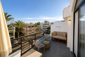 a balcony with a couch and a view of a city at Deniz Boutique Hotel in Antalya