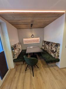 a dining room with a table and two chairs at Garni Nill in Schwendau