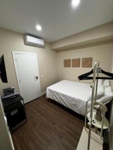 a hotel room with a bed and a treadmill at Casa da Praça- Boutique Rooms in Tavira