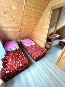 a room with three beds in a attic at Gościniec u Dzięcioła in Milonki