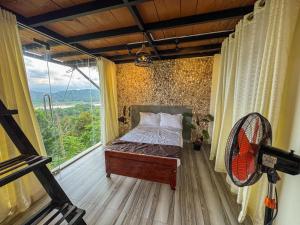 a bedroom with a bed and a large window at Victoria Sky Crest - Kandy in Teldeniya