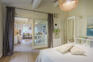 a bedroom with a bed and a living room at The Crystal Vine Lounge in Montecarlo