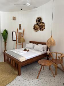 a bedroom with a bed and a table and chairs at Jumbo Resort in Paje