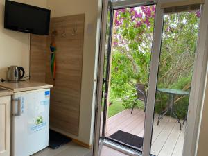 a kitchen with a sliding glass door leading to a deck at ATOSTOGAUTI GERA in Palanga