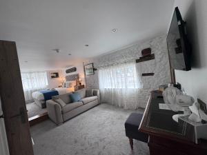 a living room with a couch and a bed at The Greenman Fownhope Hereford in Fownhope