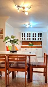 a kitchen with a dining room table and chairs at casa al mare kalispera in Marina di Mancaversa