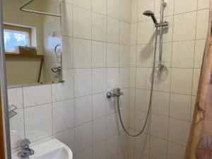 a bathroom with a shower with a toilet and a sink at ATOSTOGAUTI GERA in Palanga