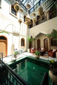 an indoor swimming pool in a building with a pool at Riad Golden in Rabat