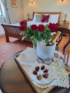 a table with a plate of cookies and roses at Corthna Lodge in Schull +13 photos
