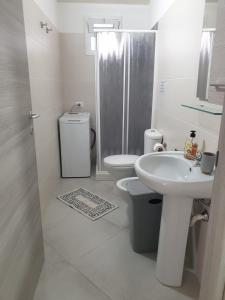 a bathroom with a toilet and a sink and a shower at Casa via maucini in Pachino