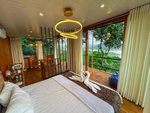 a bedroom with a bed and a large window at Victoria Sky Crest - Kandy in Teldeniya