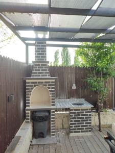 a brick oven in a patio with a fence at Villa Alaf I Kalkan Korunaklı I Private Pool in Kaş