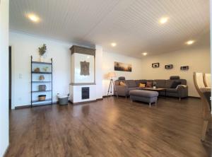 a large living room with couches and a fireplace at Dat tweete Tohuus in Soltau