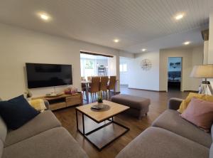 a living room with two couches and a tv at Dat tweete Tohuus in Soltau +19 photos