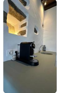 a kitchen with a coffee maker on a counter at VR Chora Apartments in Serifos Chora +6 photos
