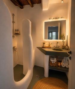 a bathroom with a sink and a mirror at VR Chora Apartments in Serifos Chora