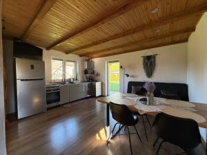 a kitchen and dining room with a table and chairs at Domek Matyjówka in Ustrzyki Dolne