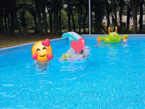 three toy characters are in a swimming pool at Manoir, vaste parc arboré in Montbron